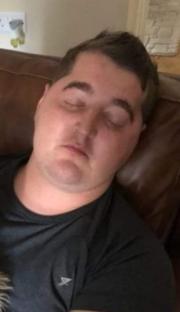 Man sleeping on a couch.