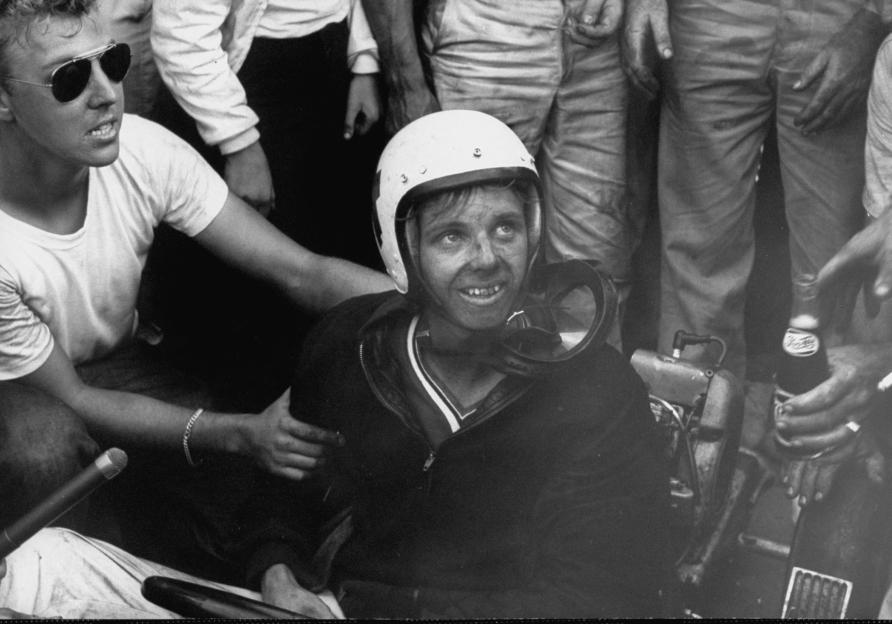 Bobby Allen, winner of the kart race, sitting in his kart, looking up and smiling.