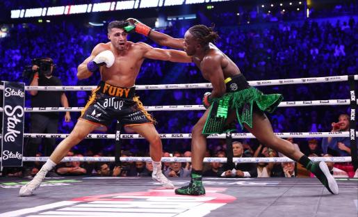 two boxers in a ring with one wearing fury shorts
