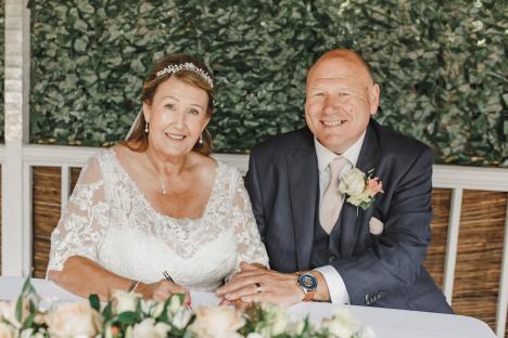 Bride and groom signing wedding documents.