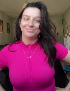 Woman in pink shirt sharing a parenting tip.