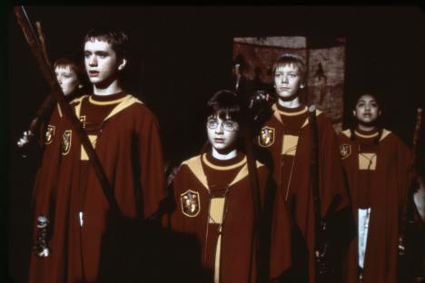 Scene from Harry Potter and the Sorcerer's Stone showing Harry Potter and other students in Gryffindor robes.