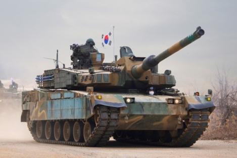 South Korean K2 Black Panther tank driving on a dirt road.
