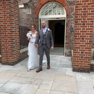 A bride and groom leaving a wedding ceremony.