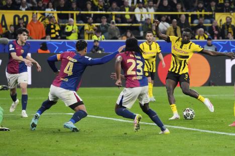 Serhou Guirassy scoring a goal during a soccer match.