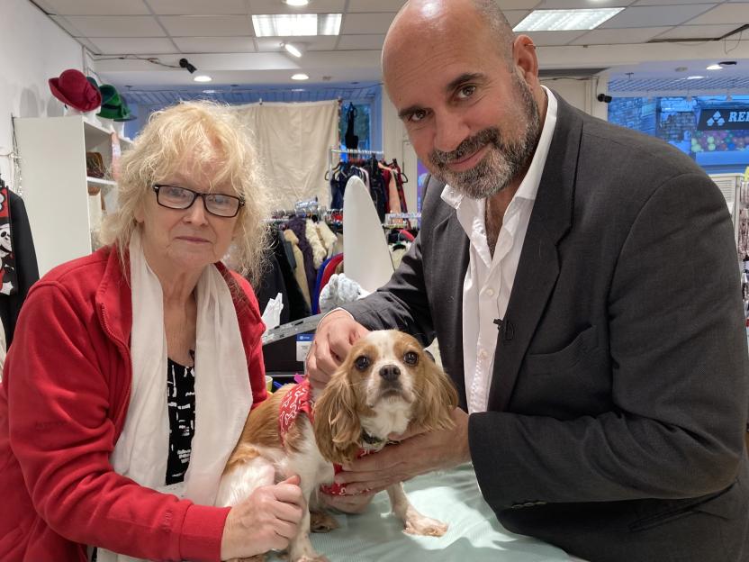 Film still of Eileen and Marc with a Cavalier King Charles Spaniel.