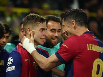 FC Barcelona's Fermin Lopez and Robert Lewandowski celebrating a goal.