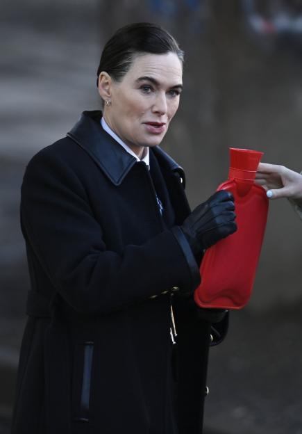 Lena Headey in character for "Project Codename" with a hot water bottle.