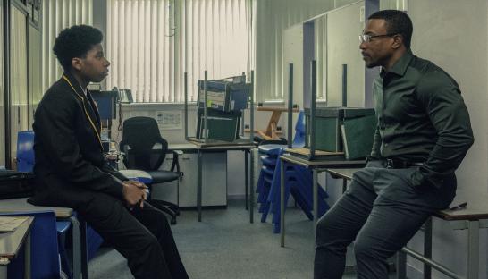 Scene from "Adolescence" showing Amari Jayden Bacchus and Ashley Walter in conversation.