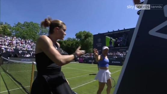 Maria Sakkari and Yulia Putintseva arguing on a tennis court.