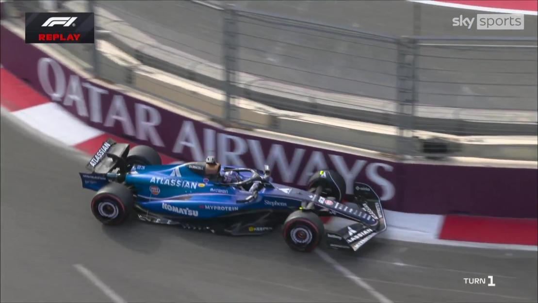 A blue Formula 1 car crashed into a white and red barrier with "QATAR AIRWAYS" written on it.