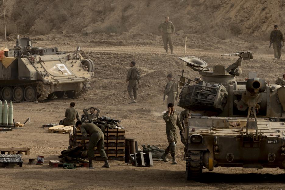 Israeli soldiers resting near artillery units near the Gaza Strip border.