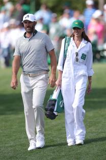 Dustin Johnson and Paulina Gretzky walking at a golf tournament.