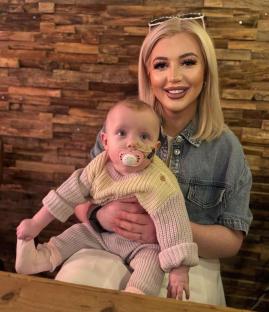 Woman holding baby in her lap.