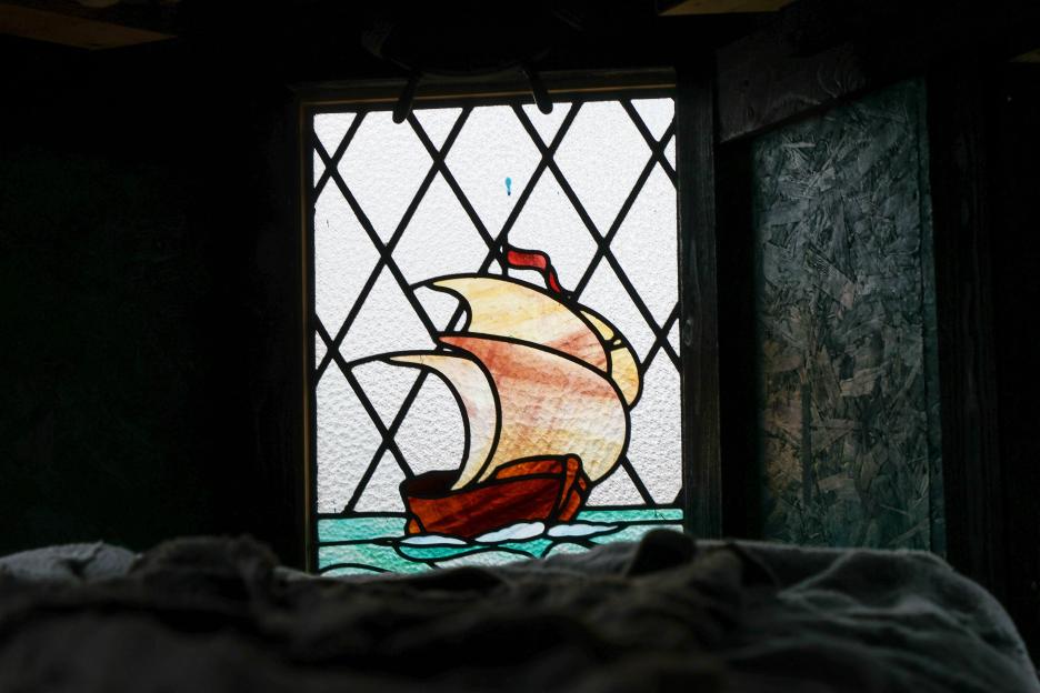 Stained glass window depicting a pirate ship.