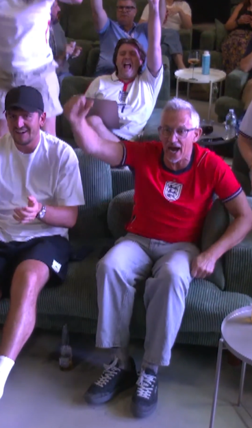 People watching a game, cheering excitedly.