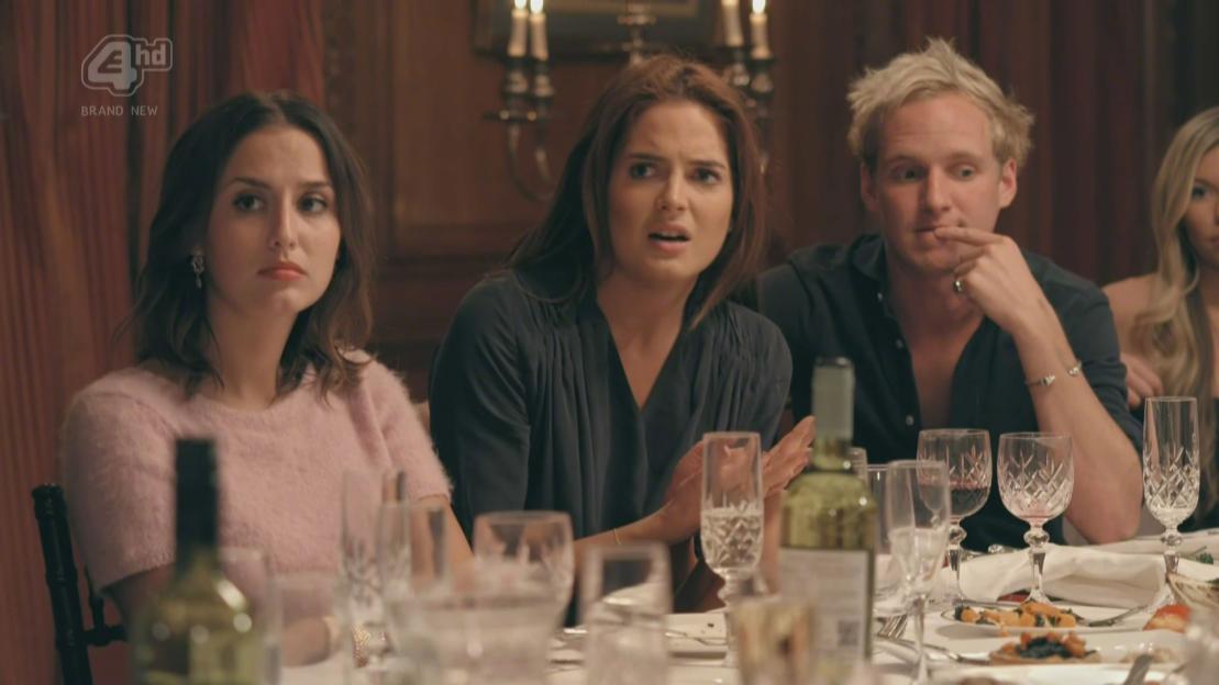 Three people, Lucy Watson, Alexandra 'Binky' Felstead, and Jamie Laing, are seated at a dinner table.