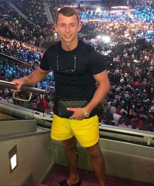 Mr Flashy Glen Ward standing in an arena full of people.