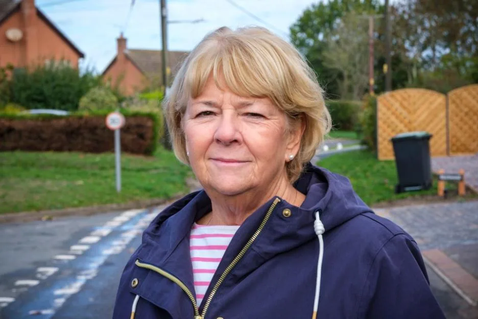 Pat Webb, a resident of Barnham, stands outside in a residential area.