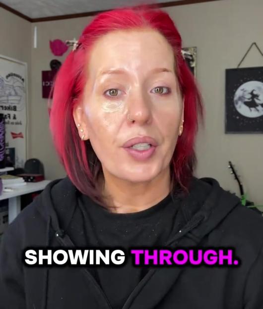 A woman with pink hair and makeup on one side of her face shows the contrast with the unmade-up side, with the words "SHOWING THROUGH" in the foreground.