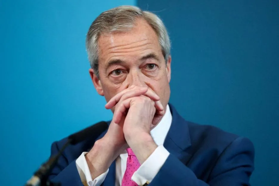 Reform UK leader Nigel Farage looks on during a press conference in London.