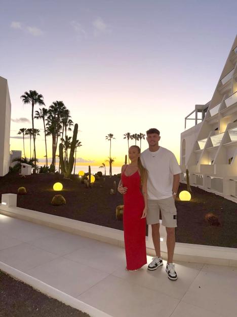 Nicole Samuel and Dylan posing together at sunset.