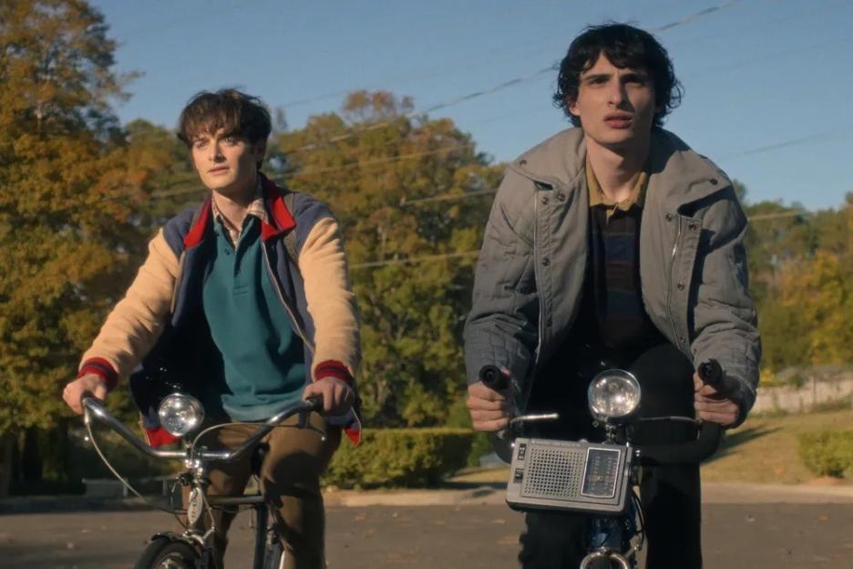 Will and Mike riding bicycles from Stranger Things season five.