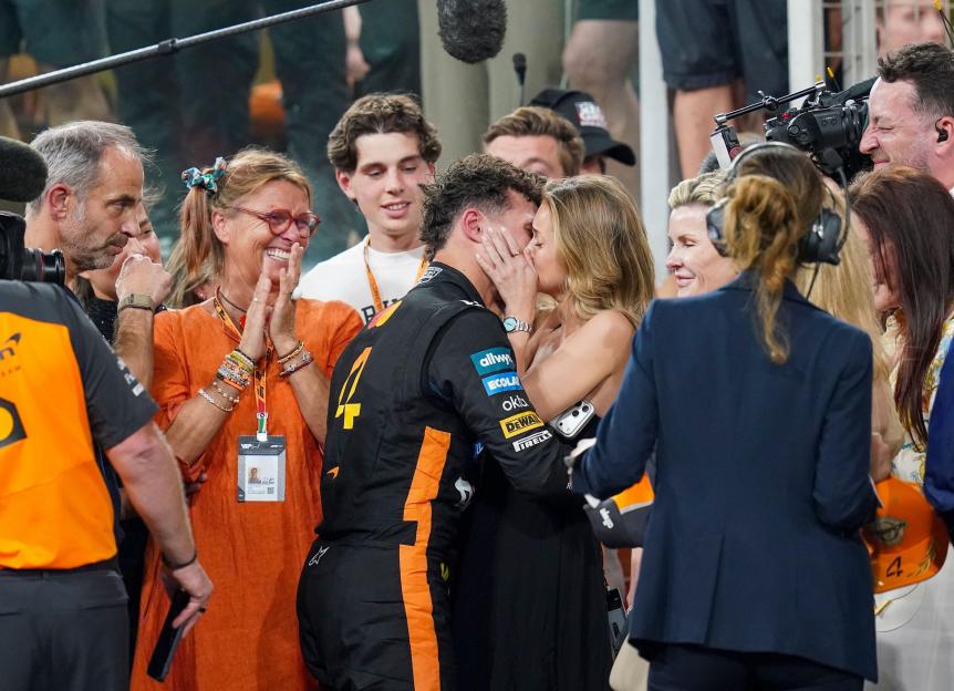 Lando Norris kisses Magui Corceiro after winning the World Drivers' Championship.