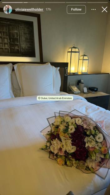 A bouquet of flowers on a bed in Dubai.