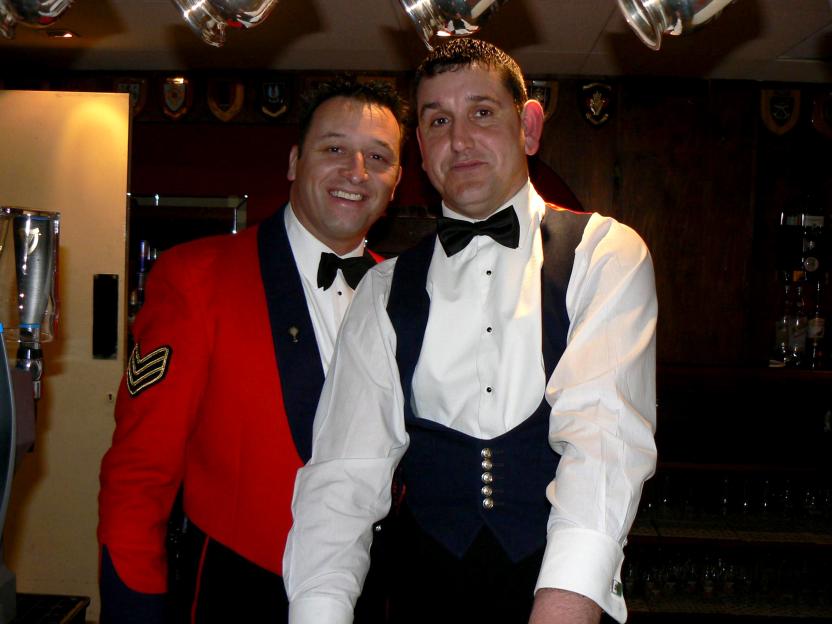 Gareth Lloyd, in a red military jacket, and Phillip Jones, in a tuxedo, pose together.