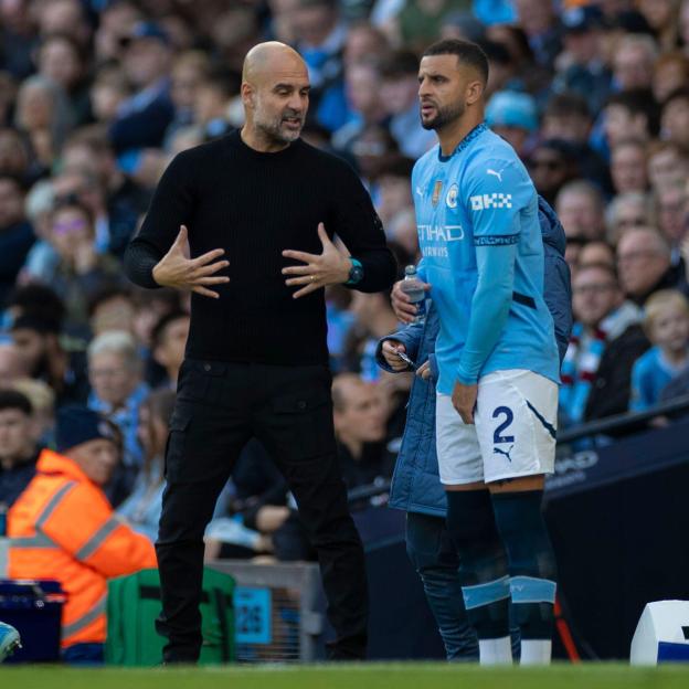 Pep Guardiola giving instructions to Kyle Walker during a match.