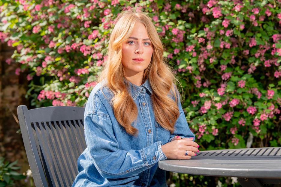 Alex Hughes, who wants alcohol sales banned on delivery apps, seated at a garden table.