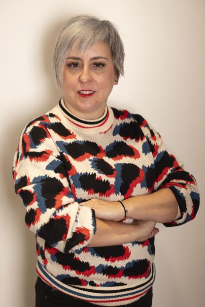 Nuria Gonzalex Lopez, human rights lawyer, wearing a colorful patterned sweater.