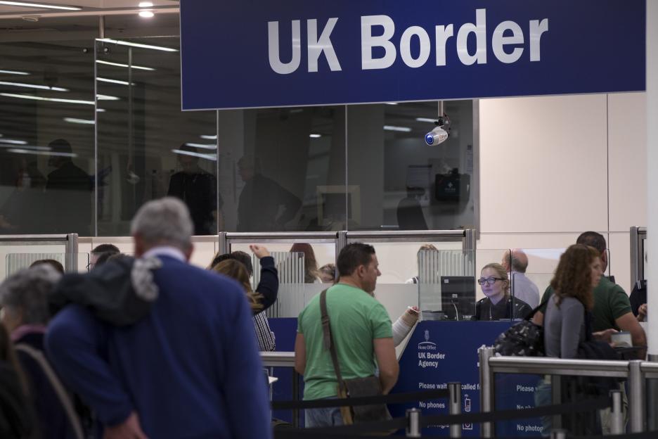 Passengers waiting in line at UK Border control at Gatwick Airport.