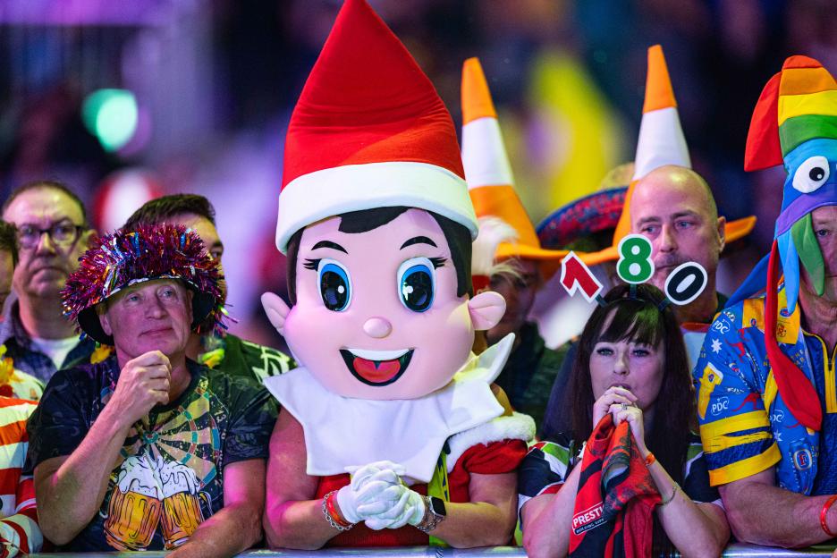 Fans in fancy dress, including an Elf on the Shelf costume and traffic cone hats, at the 2025 PDC Ladbrokes Players Championship Finals.