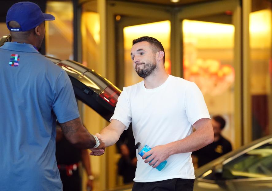 John McGinn shaking hands with a man outside the team hotel.