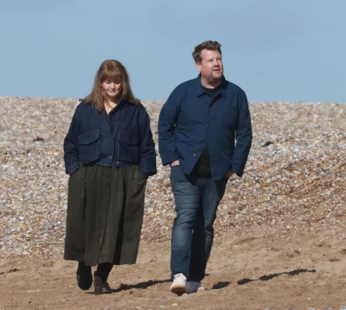 James Corden and Ruth Jones walking on a beach during the filming of their new comedy-drama series, The Choir.