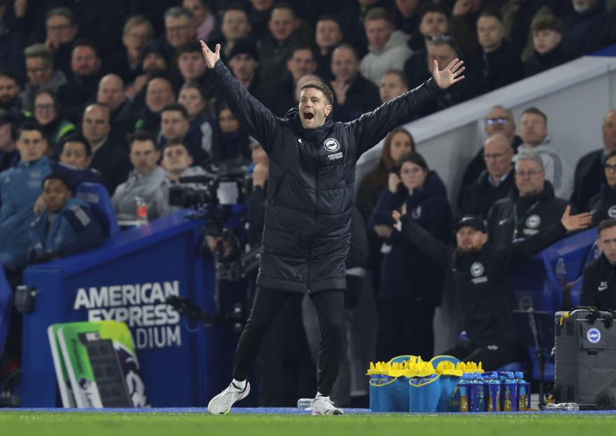 Fabian Hurzeler, Manager of Brighton & Hove Albion, with arms raised and mouth open, during a Premier League match.