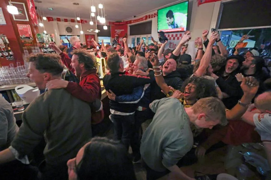 Arsenal fans celebrating inside the Tollington Arms pub on Hornsey Road.