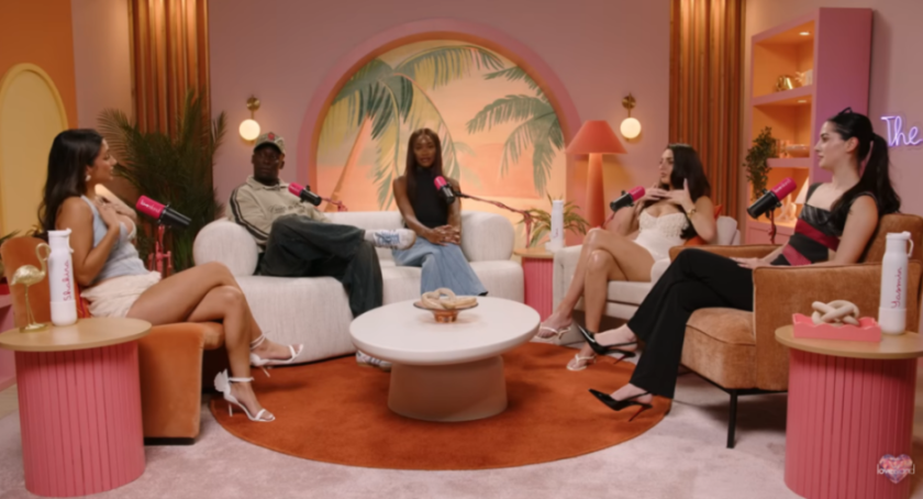 Five people sitting on couches and chairs, participating in a podcast recording.