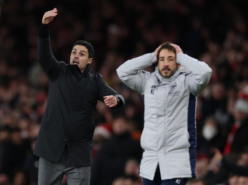 Mikel Arteta giving instructions and another coach looking dejected during Arsenal v Brighton & Hove Albion match.