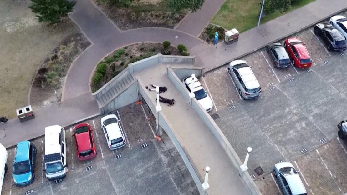 Drone view of suspected shooters lying on a pedestrian bridge at Bondi Beach in Sydney.