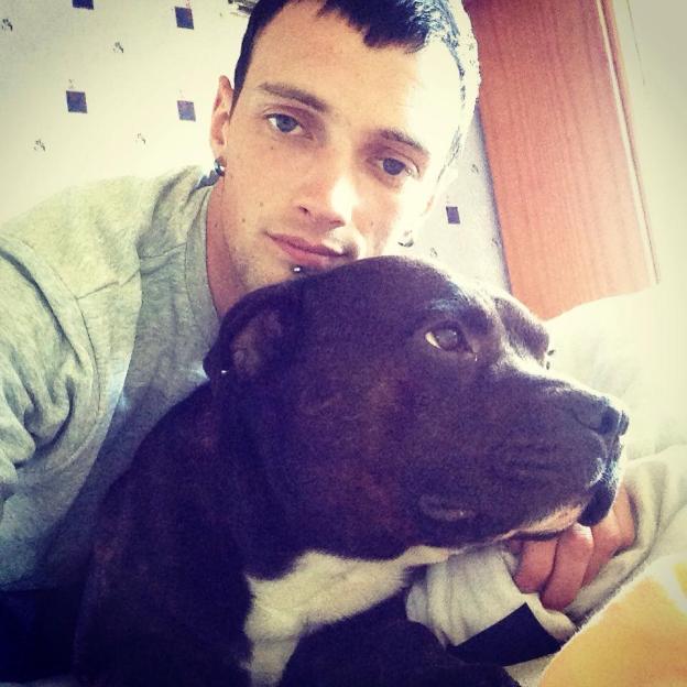 Jay Bayliss posing for a photo with a dog.