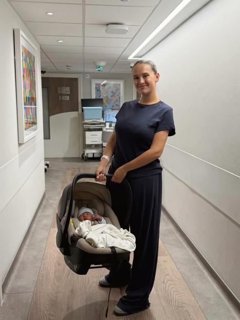 Molly-Mae carrying her newborn in a car seat.