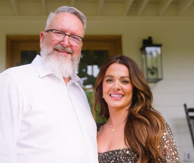 A smiling man with a white beard and glasses next to a smiling woman with long brown hair.