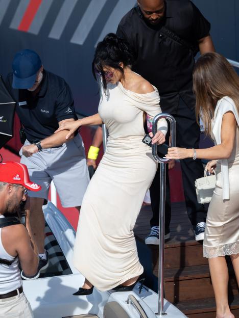 Kim Kardashian descending steps from a boat with assistance at the F1 Grand Prix of Monaco.