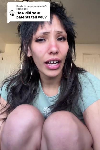 A person with black hair and a red nose, with a white speech bubble above their head that reads, "How did your parents tell you?"