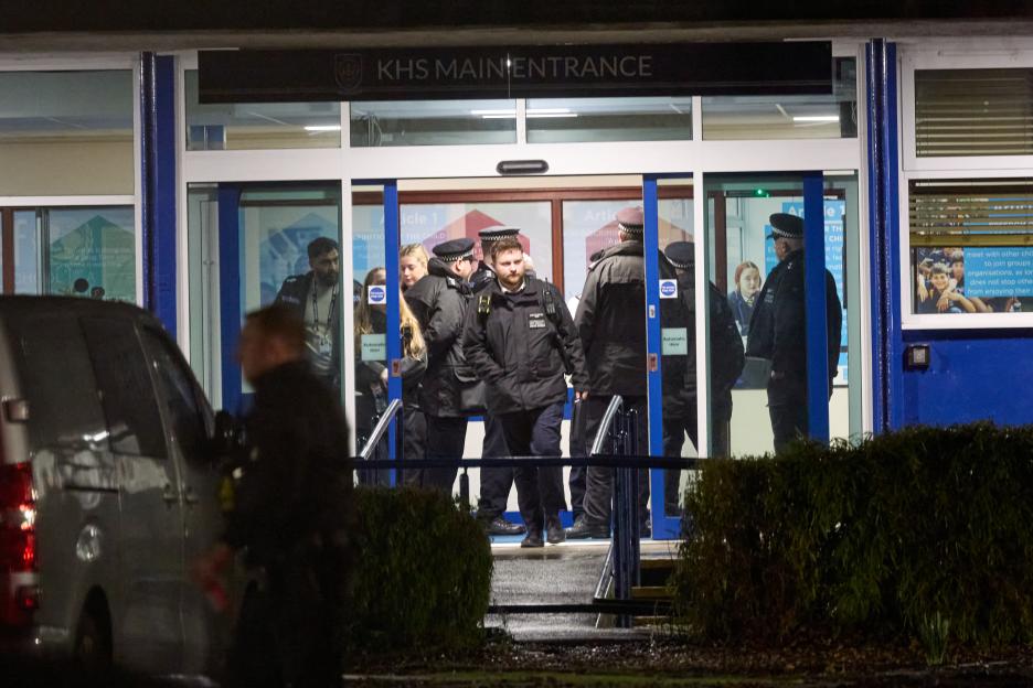 Police officers stand at the KHS Main Entrance after a double stabbing incident at Kingsbury High School.