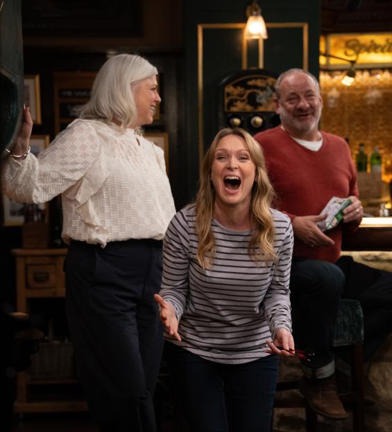 Vanessa Woodfield laughing in a pub with Dr. Todd and Manpreet Sharma.