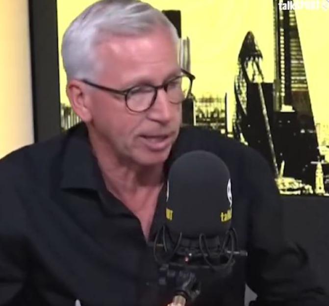 A man with grey hair and glasses speaking into a microphone.